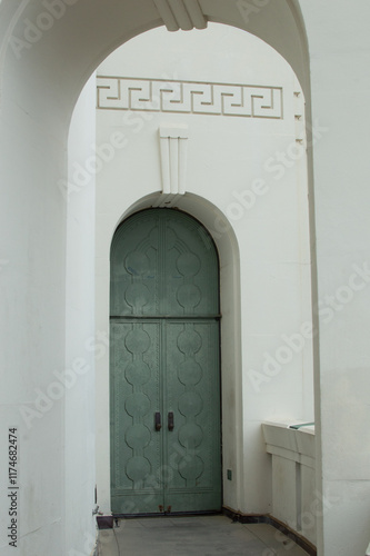 Green archway door in Art Deco style building