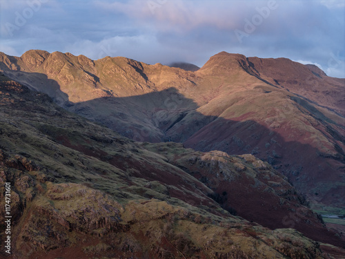 Beautiful aerial drone landscape image of Blea Tarn and Langdale Valley in Lake District during vibrant Autumn sunrise photo