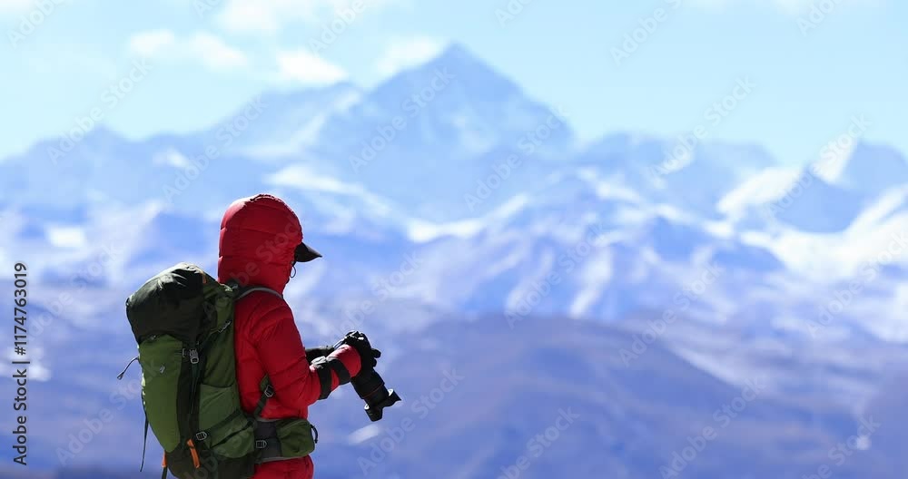 Backpacking woman photographer taking photo with Mount Everest in the background Backpacking woman photographer taking photo with Mount Everest in the background