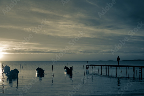 Winter morning on the Razim saltwater lake in the traditional fishing village of Sarichioi, one of the largest lakes in Romania, part of the Danube Delta Biosphere Reserve, Tulcea County, Romania photo