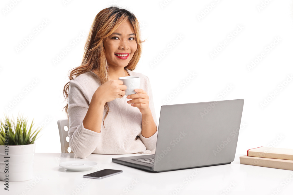 Young asian woman working on a laptop computert and having a cup of coffee Young asian woman working on a laptop computert and having a cup of coffee