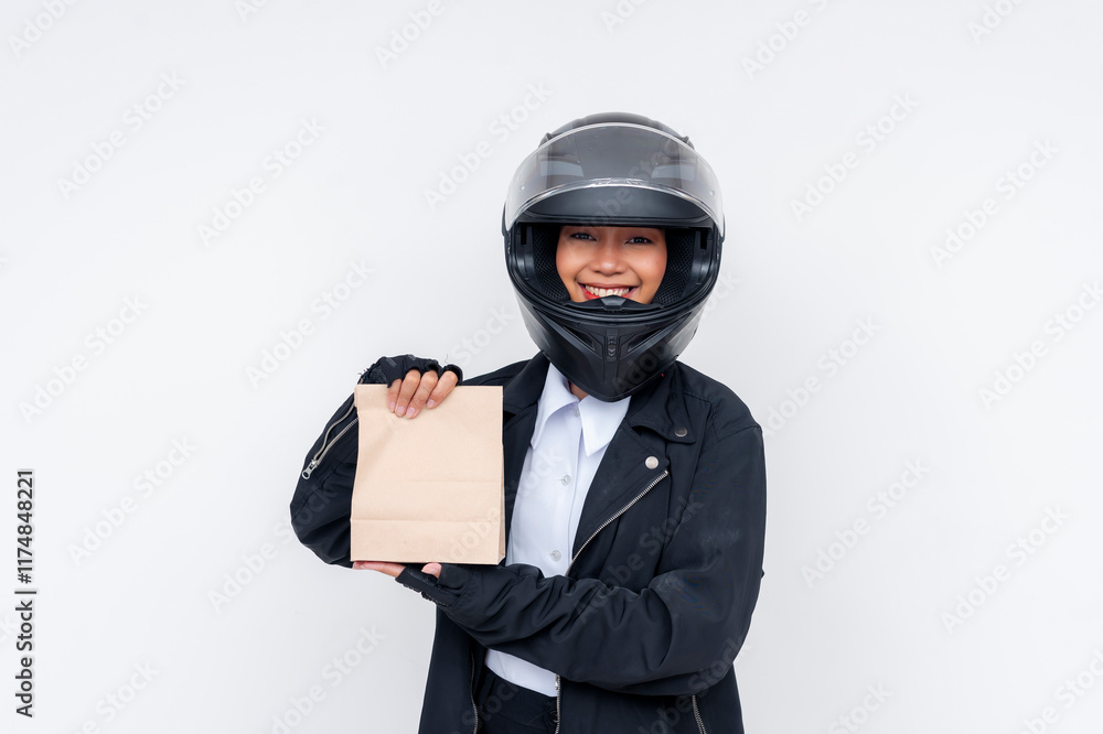 Motorcycle delivery person holding takeout bag while smiling, wearing black jacket and helmet Motorcycle delivery person holding takeout bag while smiling, wearing black jacket and helmet
