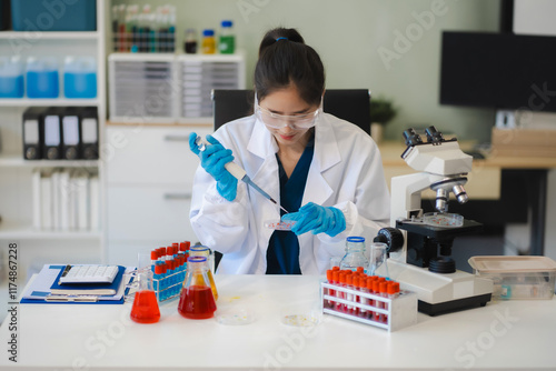 Female biotechnologist testing new chemical substances in a laboratory. photo