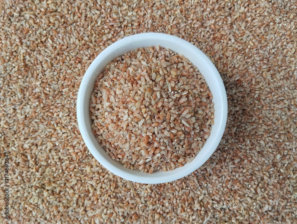 Red rice in bowl with rice background. Top view angle setup, Asian raw food Red rice in bowl with rice background. Top view angle setup, Asian raw food