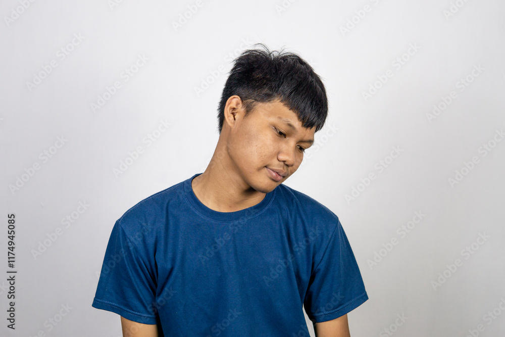 Handsome Asian young man wearing blue t-shirt sweater looking sleepy and tired, exhausted from tiredness, lazy eyes in the morning. isolated on white background Handsome Asian young man wearing blue t-shirt sweater looking sleepy and tired, exhausted from tiredness, lazy eyes in the morning. isolated on white background