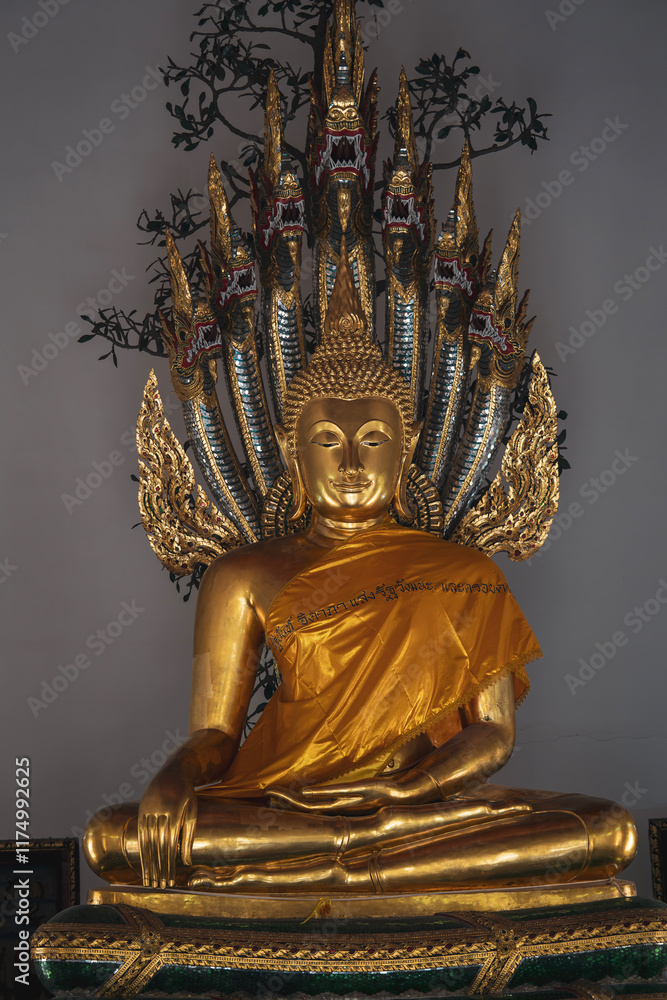 Fototapeta premium Statue of Buddha guarded by a serpent at Wat Arun, Bangkok 
