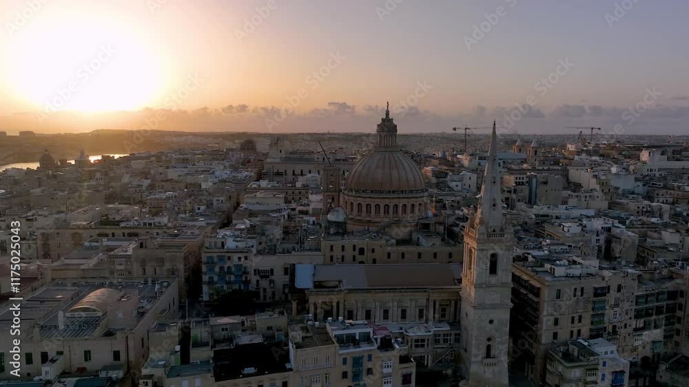 Aerial view of Beautiful sunset over Valletta with historic architecture and coastal view of Malta in the distance