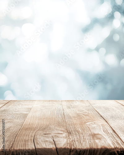 A light oak wooden plank table top with a smooth finish, standing out against a blurred abstract background of cool blues and whites 