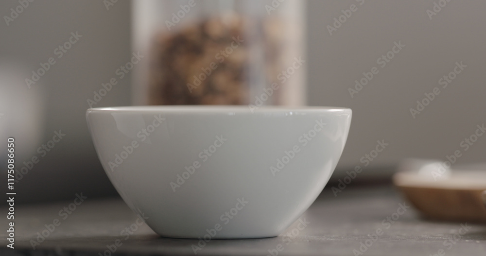 Fototapeta premium white bowl with granola on terrazzo countertop