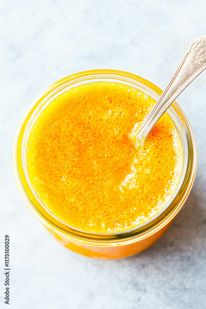 Freshly blended mango and orange smoothie in a glass jar Freshly blended mango and orange smoothie in a glass jar
