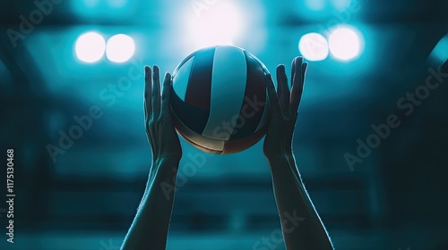 Volleyball player hands raise ball high in arena