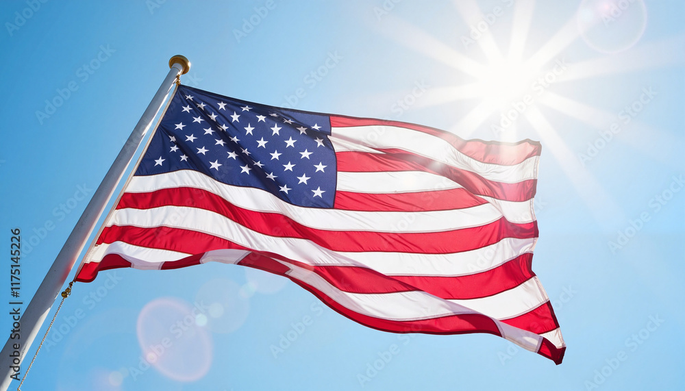 Obraz premium American flag waving in bright sunlight against blue sky