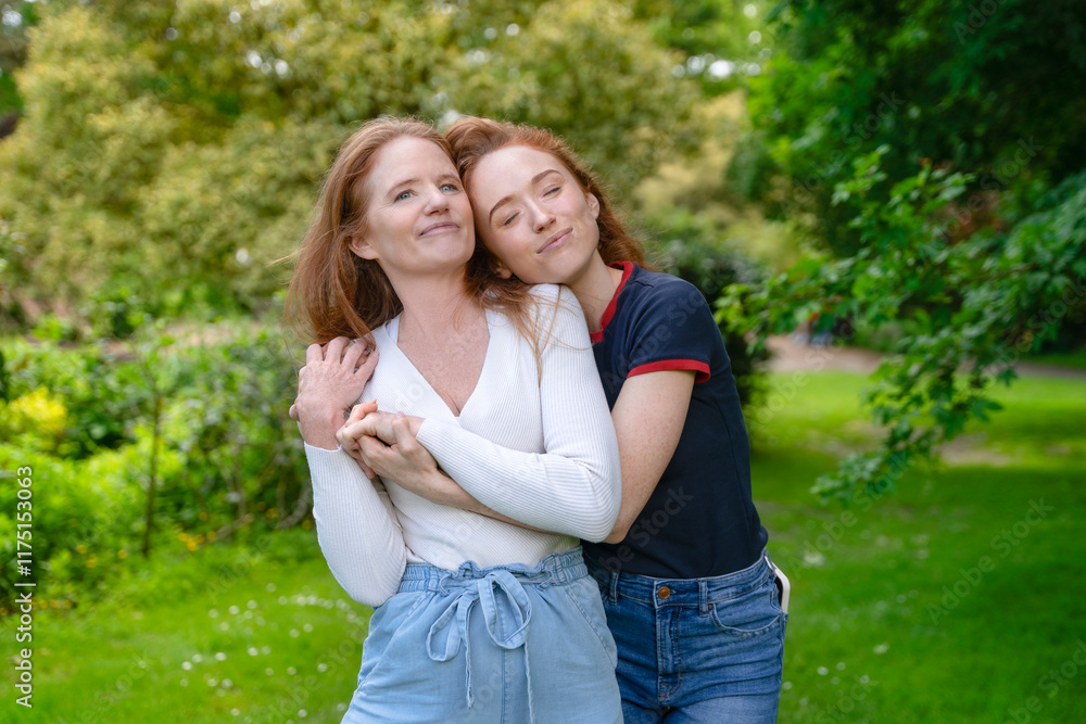 Two friends enjoying a joyful moment together in a lush green park on a sunny day Two friends enjoying a joyful moment together in a lush green park on a sunny day
