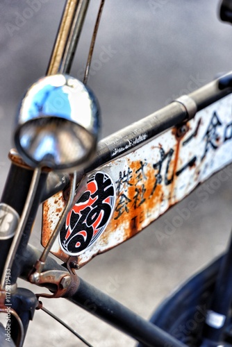 Amidst the modern skyscrapers and bustling streets of Tokyo, a forgotten piece of history stands still — a vintage bicycle. photo