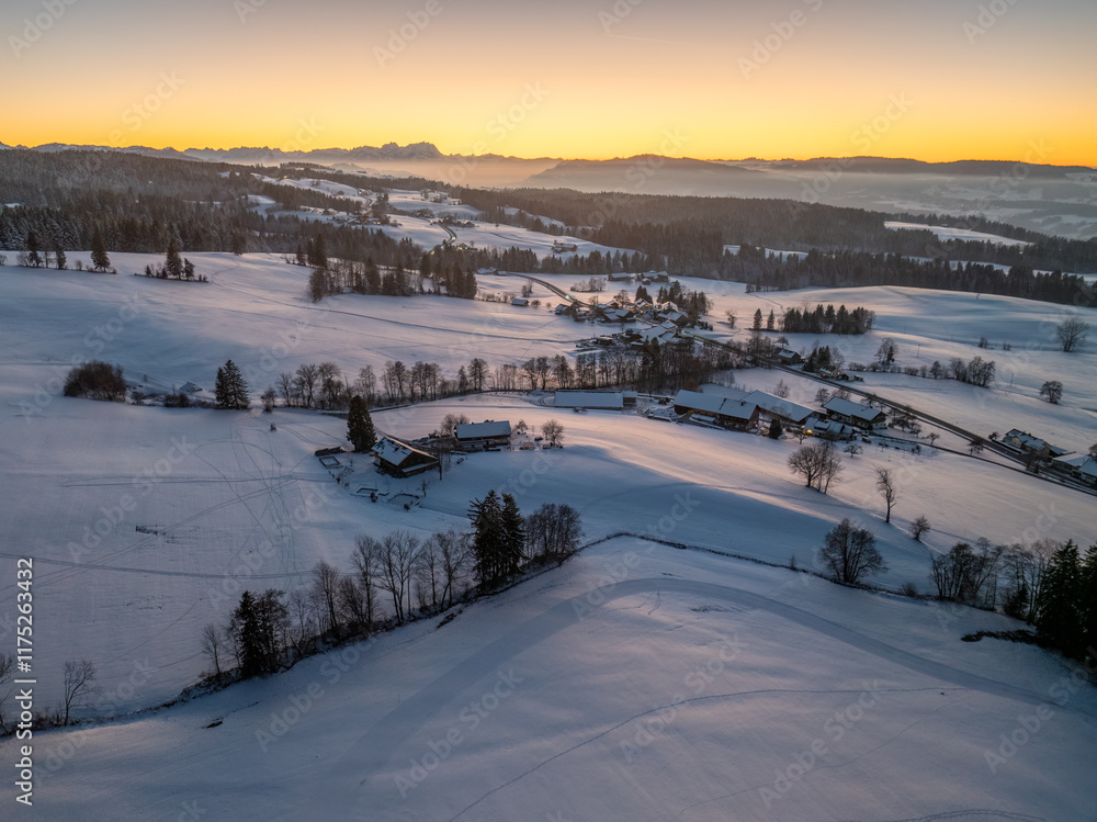 Aerial photo of snowy landscape in moody sunset twilight in the Allgaeu mountains next to Oberreute in Bavaria, Germany Aerial photo of snowy landscape in moody sunset twilight in the Allgaeu mountains next to Oberreute in Bavaria, Germany