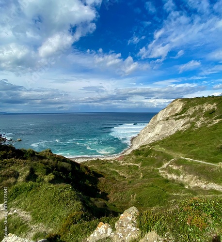 Stunning landscape in Northern Spain. Waves are hitting the shore of the bay.