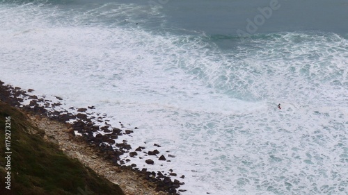 Surfer catching the waves on cloudy day