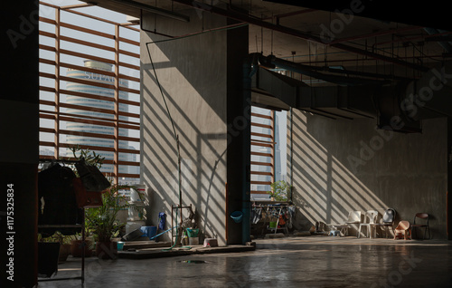 Obraz na płótnie Morning sunlight shines through Wooden Battens to The washing area for maid and Variety of Chairs near concrete wall on parking lot of Condominium building. use it as your Wallpaper, Poster and Space. w salonie