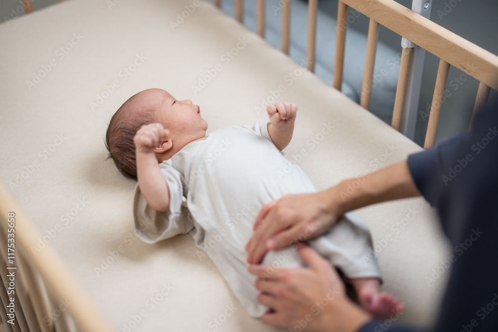 Mum massage on baby tummy at home