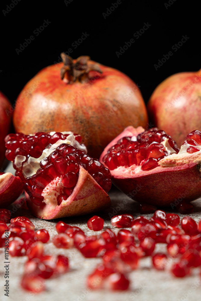 Ripe pomegranates, peeled and whole, the concept of benefits and vitamins in fruit.