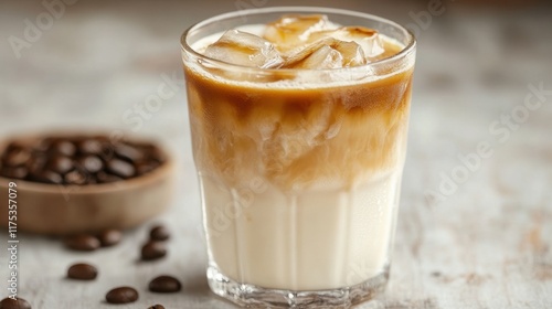 Close-up of an iced coffee lemonade glass, with the focus on condensation and layered tones of coffee and lemonade.