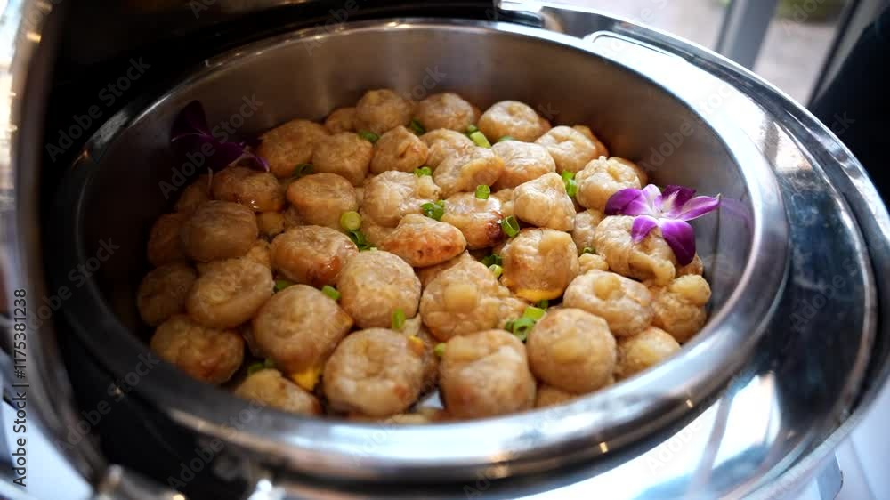 Delicious crispy golden-brown pastries garnished with chopped green onions, served on a metal tray. Perfect for culinary presentations, restaurant menus, or food advertisements. Delicious crispy golden-brown pastries garnished with chopped green onions, served on a metal tray. Perfect for culinary presentations, restaurant menus, or food advertisements.