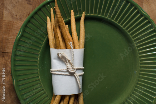 Top view of fried corn stick snack on a green plate, Overhead view of nigerian kokoro corn snack photo