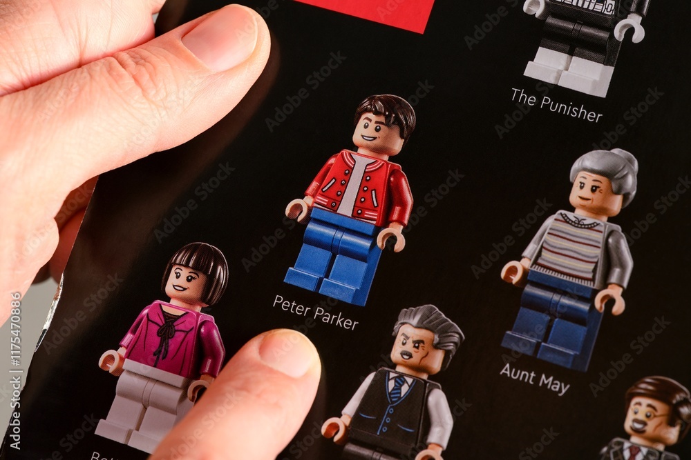 Obraz premium Tambov, Russian Federation - January 02, 2025 Woman fingers pointing out Lego Peter Parker minifigure on a Lego Marvel cardboard box