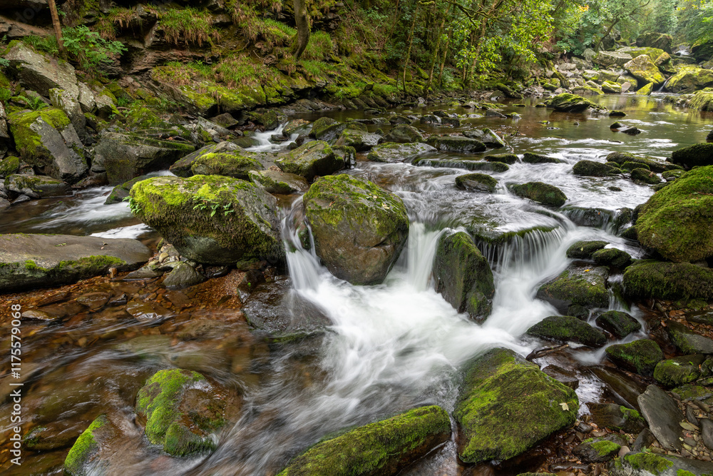 Long exposure of a waterfall on the East Lyn river at Watersmeet in Exmoor National Park Long exposure of a waterfall on the East Lyn river at Watersmeet in Exmoor National Park
