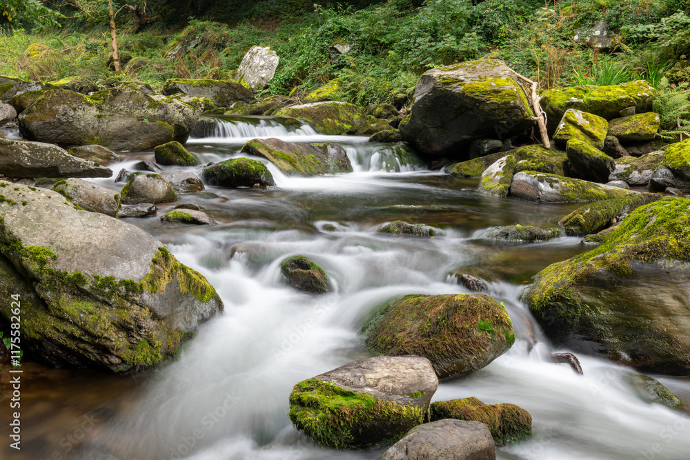 Long exposure of a waterfall on the East Lyn river at Watersmeet in Exmoor National Park Long exposure of a waterfall on the East Lyn river at Watersmeet in Exmoor National Park