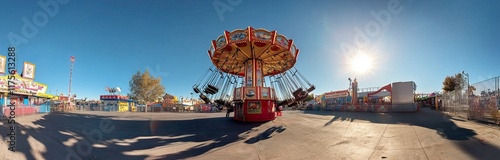 Colorful amusement park rides under a bright blue sky. Background AI generated image