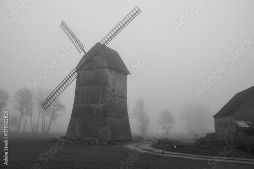 Kozlak windmill in the fog in Boruja Koscielna, Poland photo