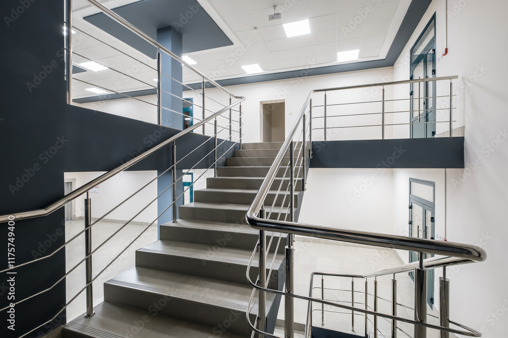Fototapeta premium stairs emergency and evacuation exit stair in up ladder in a new office building at night