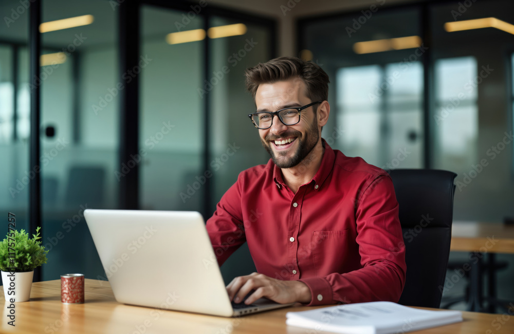 Happy businessman working on laptop in office. Man smiling and typing on computer. Success and satisfaction evident. He is in an office interior. Indoor setting. Modern tech tools. Corporate setting. Happy businessman working on laptop in office. Man smiling and typing on computer. Success and satisfaction evident. He is in an office interior. Indoor setting. Modern tech tools. Corporate setting.