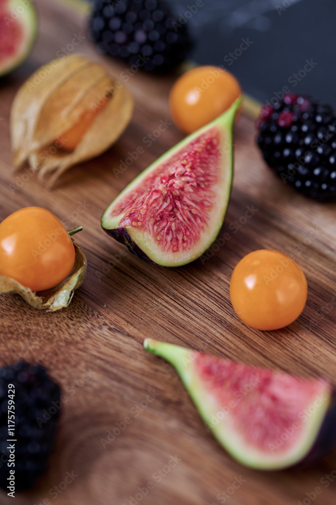 Physalis, fig and blackberries on the cutting board Physalis, fig and blackberries on the cutting board
