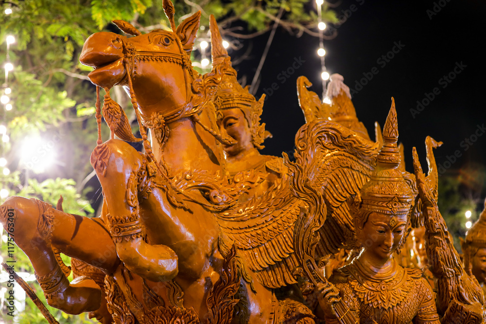 Fototapeta premium Ubon Ratchathani, Thailand - July 21, 2024: Buddhist Lent tradition, people organize a candle procession and beautiful wisdom performance, which is a unique beeswax candle to create art as a Buddhist 