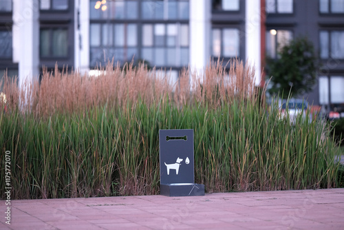 Outdoor watering station for dogs in a modern quarter of the city against the backdrop of a green lawn photo