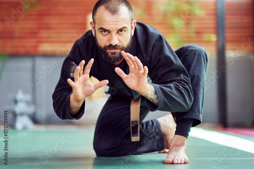 Martial arts master practicing self defense techniques in fighting pose photo