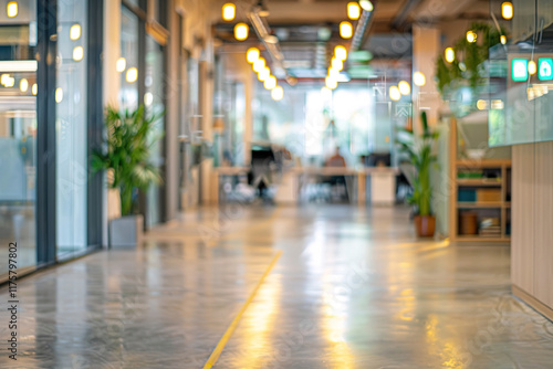 Modern office hallway with bright lighting and plants.