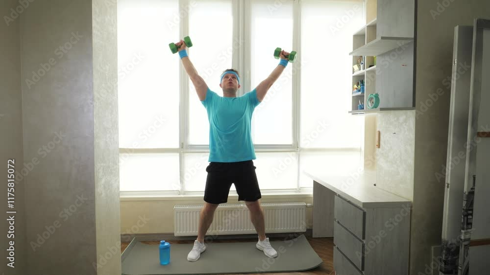 Workout at home with dumbbells on a fitness mat. Athlete jumping with dumbbells. Slow motion. Athlete in training Workout at home with dumbbells on a fitness mat. Athlete jumping with dumbbells. Slow motion. Athlete in training