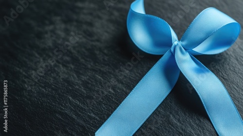 Duchenne Muscular Dystrophy Awareness Week Elegant blue ribbon bow on dark surface for gift wrapping and celebrations photo