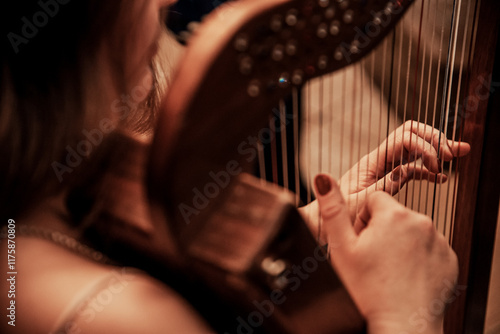 Woman play strings harp, musician harper performs at concert in nightclub bar