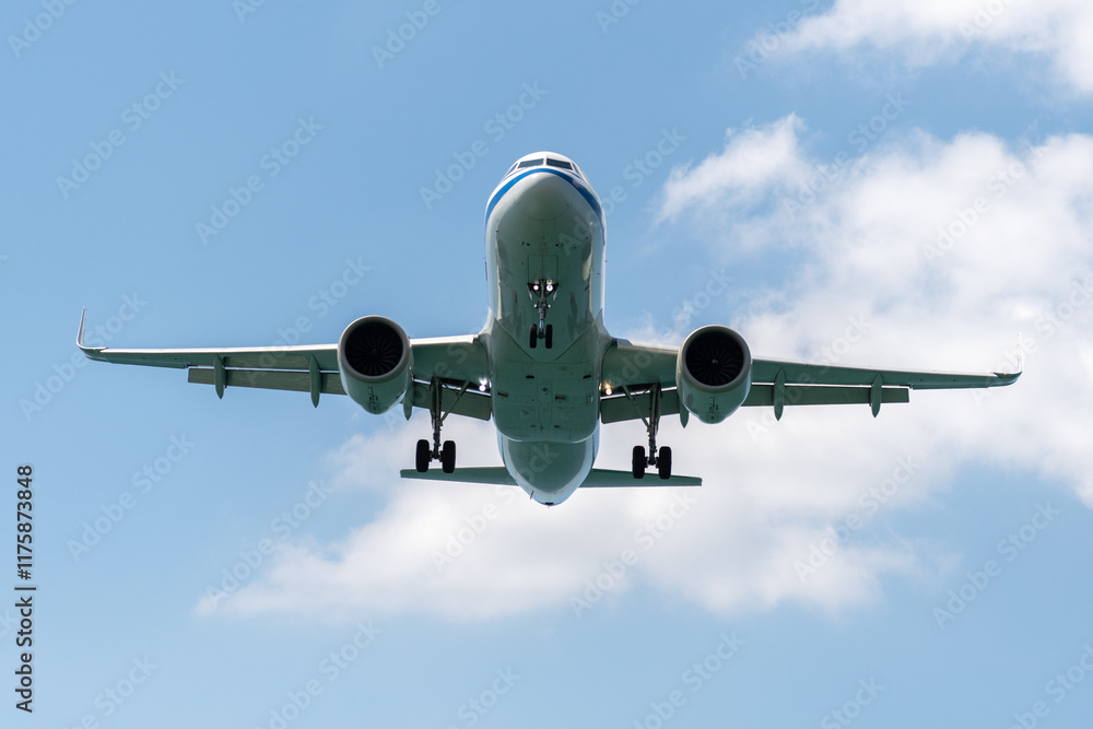 A blue sky background with an airplane prepared for landing on a well known place for plane spotter at Mao Khao Beach, Phuket, Thailand A blue sky background with an airplane prepared for landing on a well known place for plane spotter at Mao Khao Beach, Phuket, Thailand