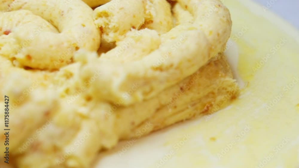 pastry chef cooks the famous king cake.close up of hands in gloves, pouring almond cream and hiding one seed.before oven woman applying with brush egg yolk over, and the sugar syrup.process of cooking pastry chef cooks the famous king cake.close up of hands in gloves, pouring almond cream and hiding one seed.before oven woman applying with brush egg yolk over, and the sugar syrup.process of cooking