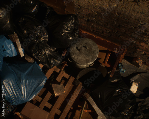 All kinds of rubbish lying on the street near a wall. A polluted urban environment. 3D render.