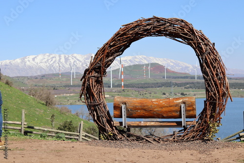 Photos A bench inside a large wooden circle overlooks a view of snowy mountains