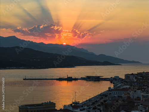 Beautiful sunset rays in the natural harbour of Samos island town, Greece