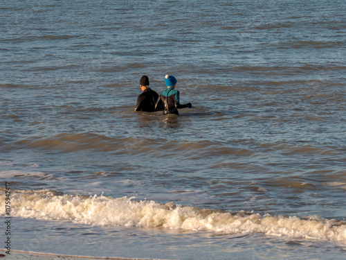 Ouistreham, France January 3, 2025. Walruses in the water in the North Sea on the beaches of Normandy. Sports, relaxation, a way to a healthy lifestyle photo