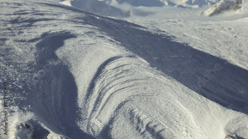 Panorama of the winter peaks of the Tatras from Kasprowy Wierch. A sunny, winter December day. The mountain peaks are covered in thick clouds.