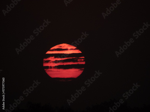 Red Sunrise with dark cloud tiger stripes
